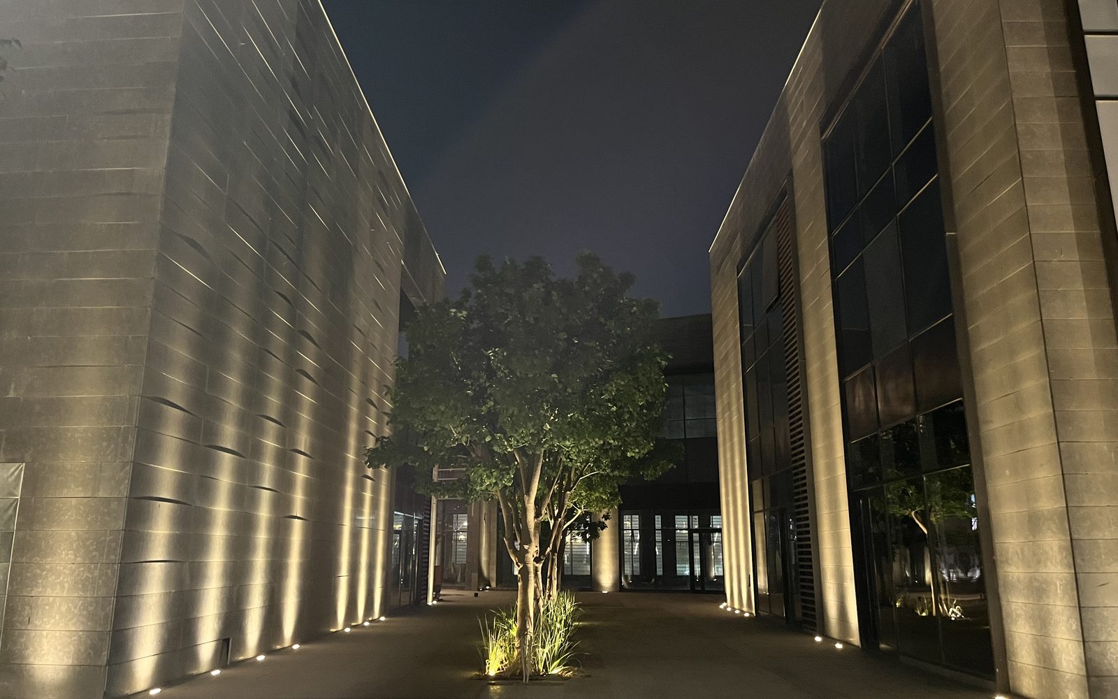 A lit lane between buildings at SKYWALK Egypt at night